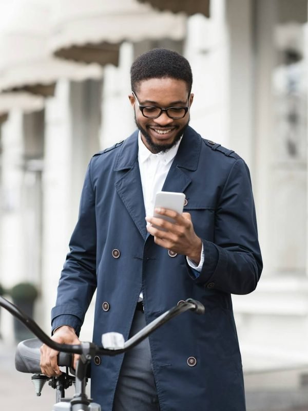 way-to-work-man-texting-on-phone-standing-with-bike.jpg